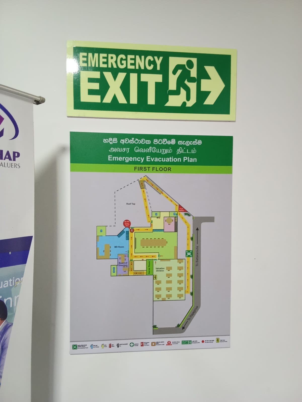 Corridor emergency evacuation map installed next to exit sign