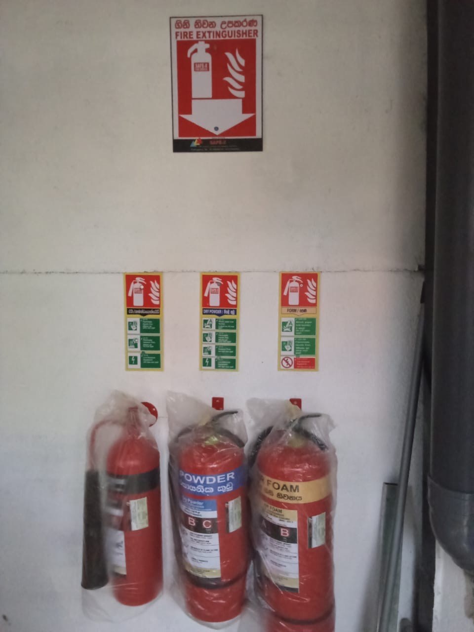 Multi-cylinder wall mounted fire extinguisher station in commercial facility