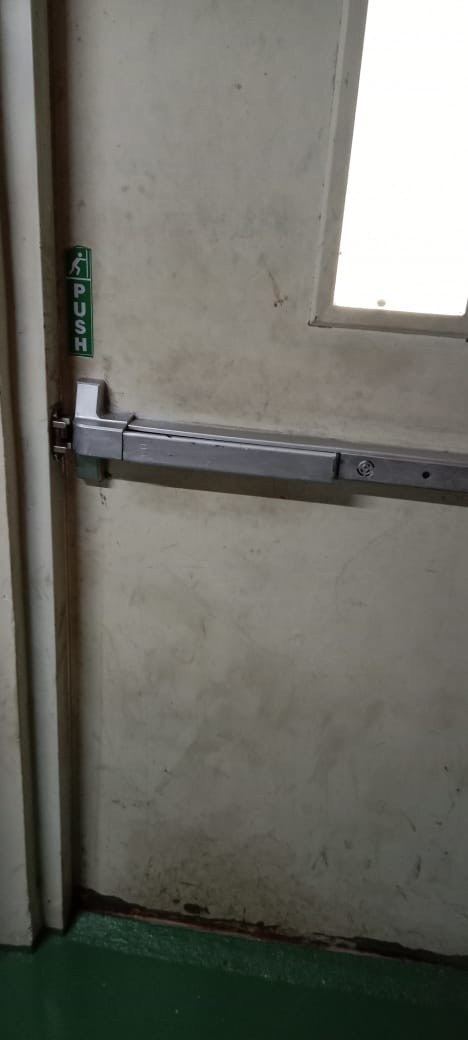 Emergency exit doorway fitted with heavy-duty panic push bar hardware